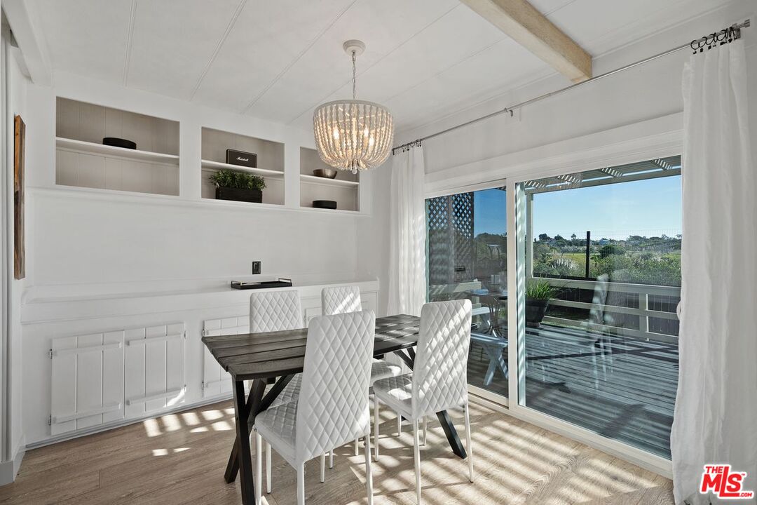 29500 Heathercliff Road, Unit SPC 103 Malibu, CA 90265 - Photo 6 of 15 a view of a dining room with furniture window and wooden floor