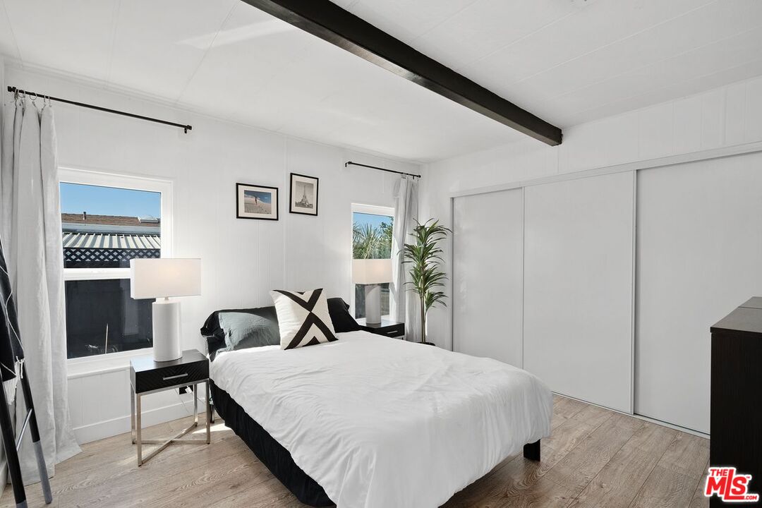 29500 Heathercliff Road, Unit SPC 103 Malibu, CA 90265 - Photo 7 of 15 a bedroom with a bed and a flat tv screen