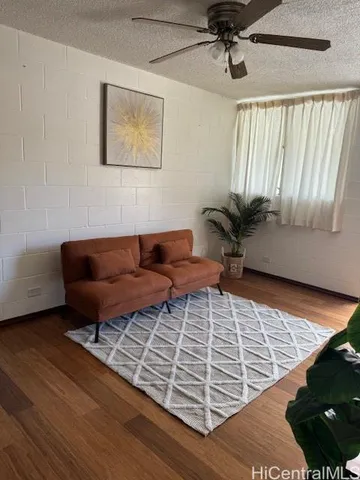 a bedroom with furniture and a wooden floor