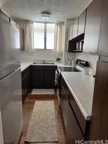 a kitchen with a sink stove and microwave