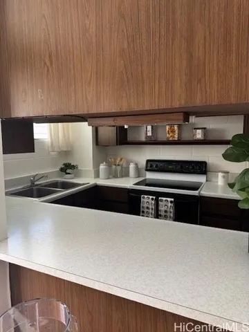 a kitchen with stainless steel appliances a sink dishwasher and a stove