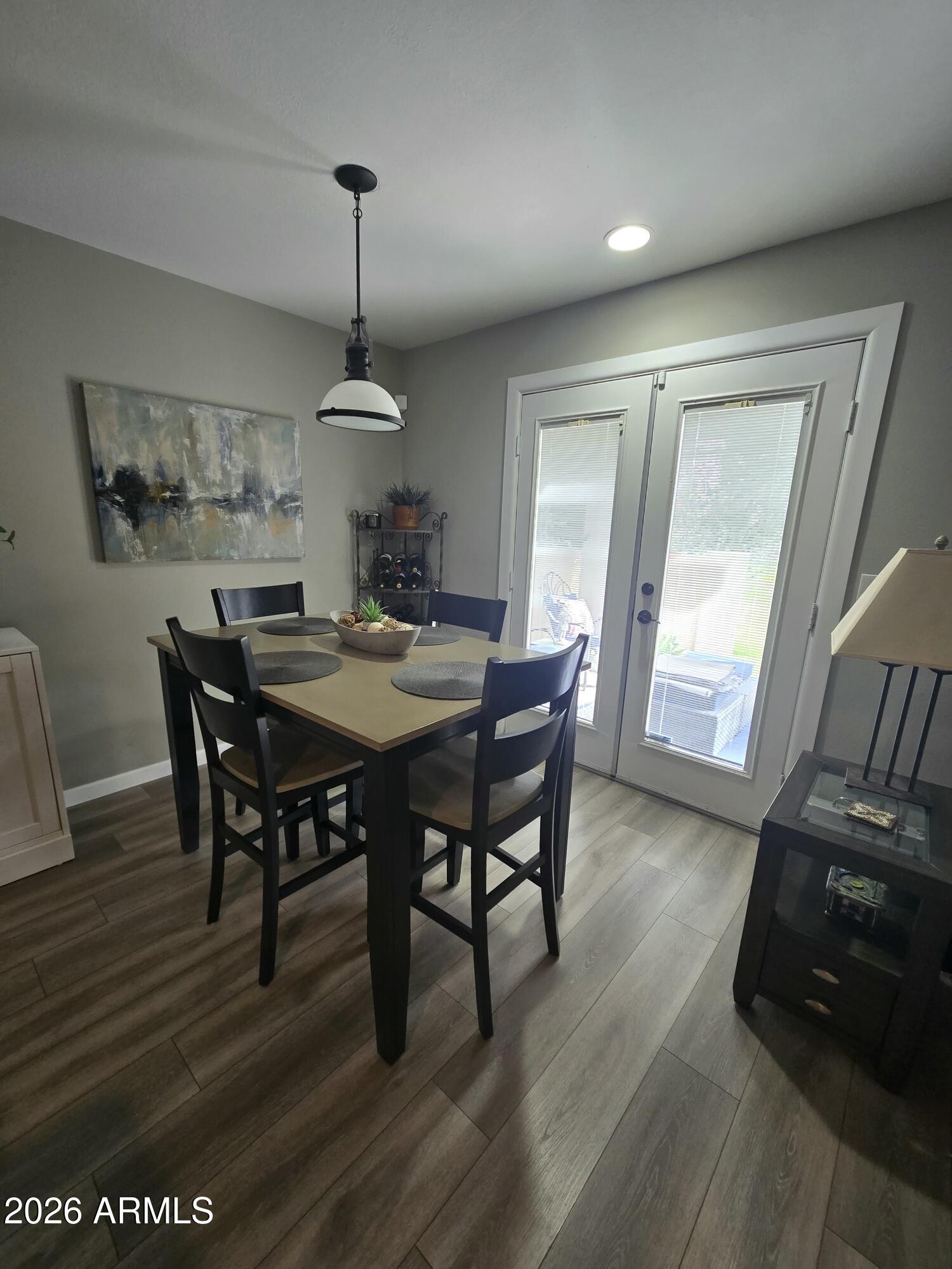 8611 South 48th Street, Unit 2 Phoenix, AZ 85044 - Photo 6 of 12 a dining room with furniture window wooden floor