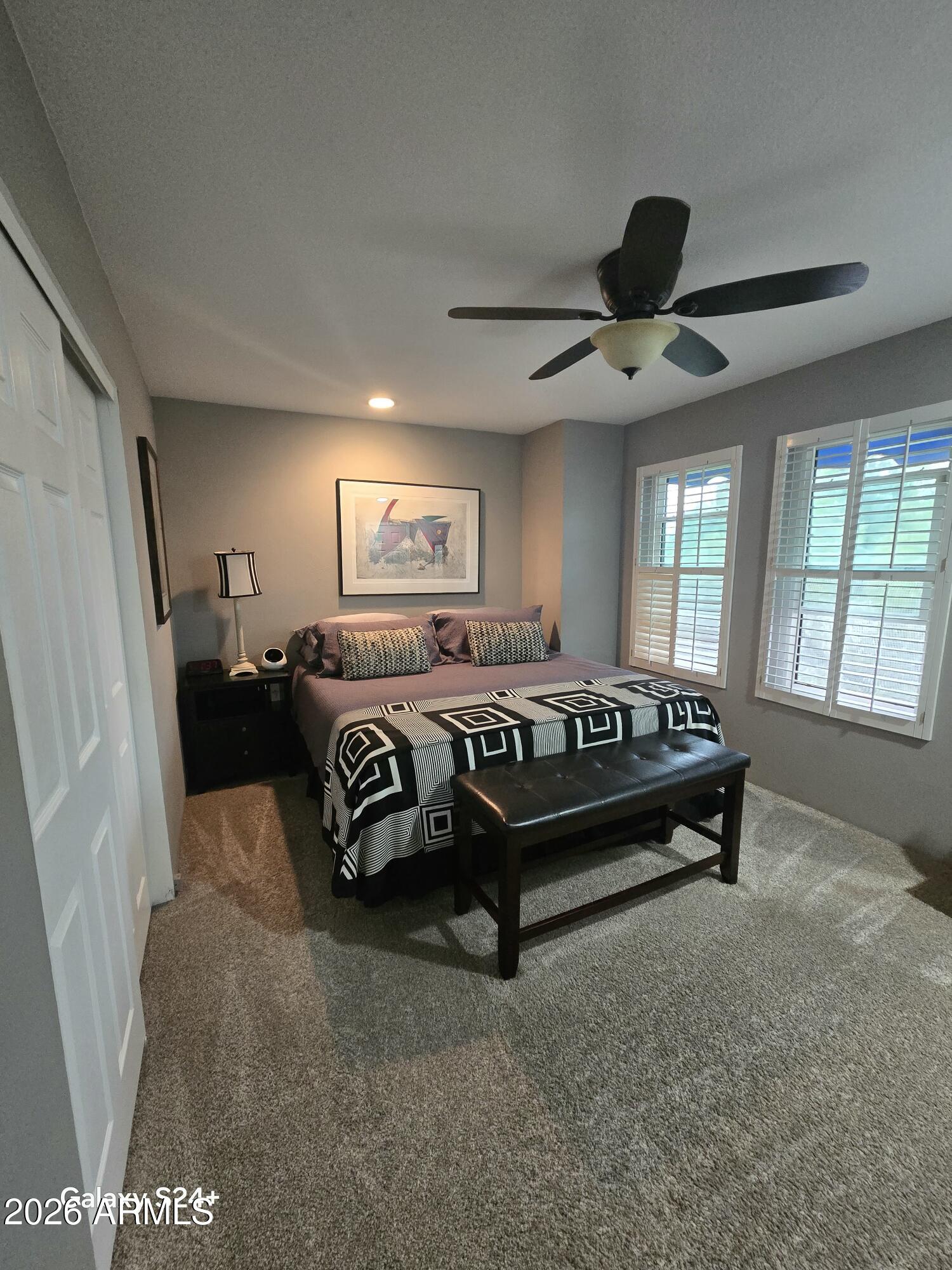 8611 South 48th Street, Unit 2 Phoenix, AZ 85044 - Photo 7 of 12 a bedroom with a bed couch and window