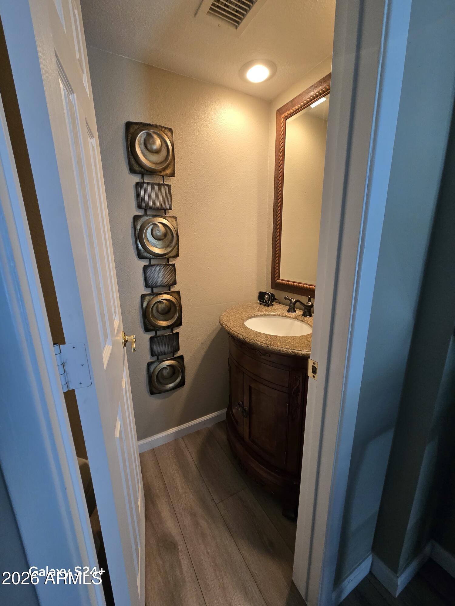 8611 South 48th Street, Unit 2 Phoenix, AZ 85044 - Photo 10 of 12 a view of a hallway with wooden floor