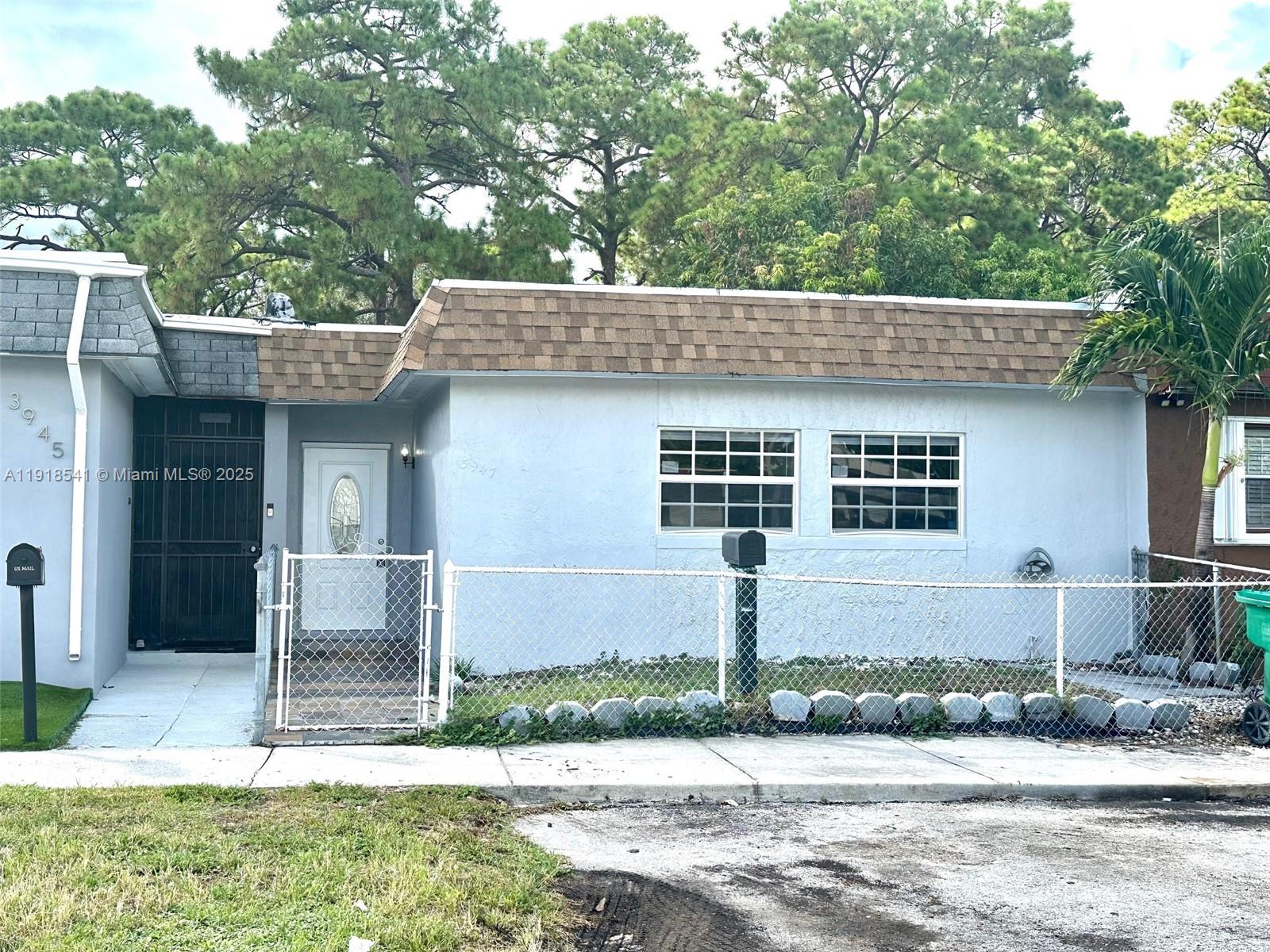 a front view of a house with garden and plants