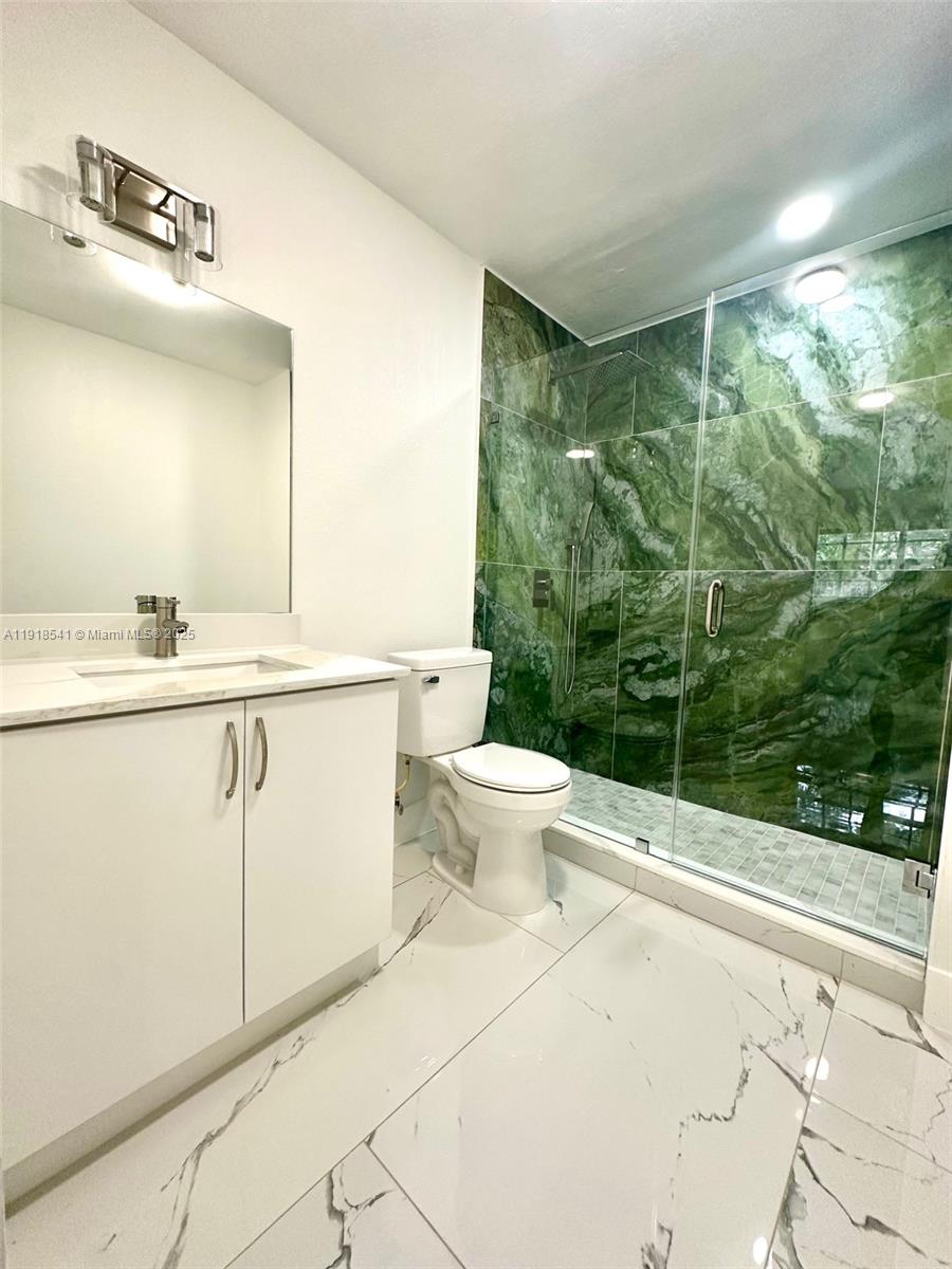 3947 Northwest 207 St Road Miami Gardens, FL 33055 - Photo 11 of 23 a bathroom with a sink mirror toilet and next to a window