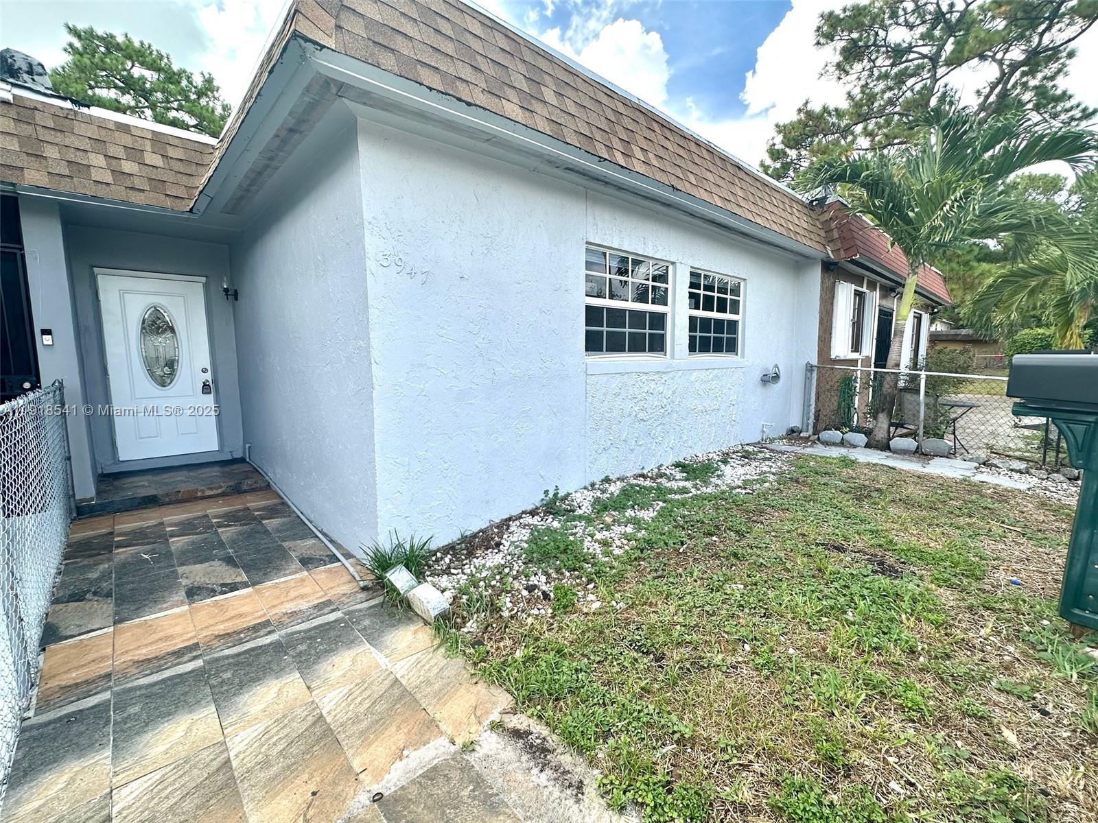 3947 Northwest 207 St Road Miami Gardens, FL 33055 - Photo 3 of 23 a front view of a house with garden