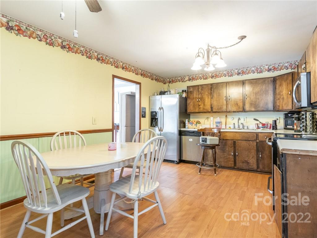 162 Alex Road Cleveland, NC 27013 - Photo 14 of 30 a dining hall with stainless steel appliances kitchen island granite countertop a table and chairs