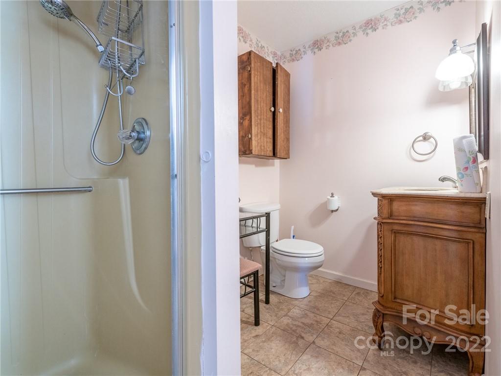 162 Alex Road Cleveland, NC 27013 - Photo 17 of 30 a bathroom with a toilet a sink and shower