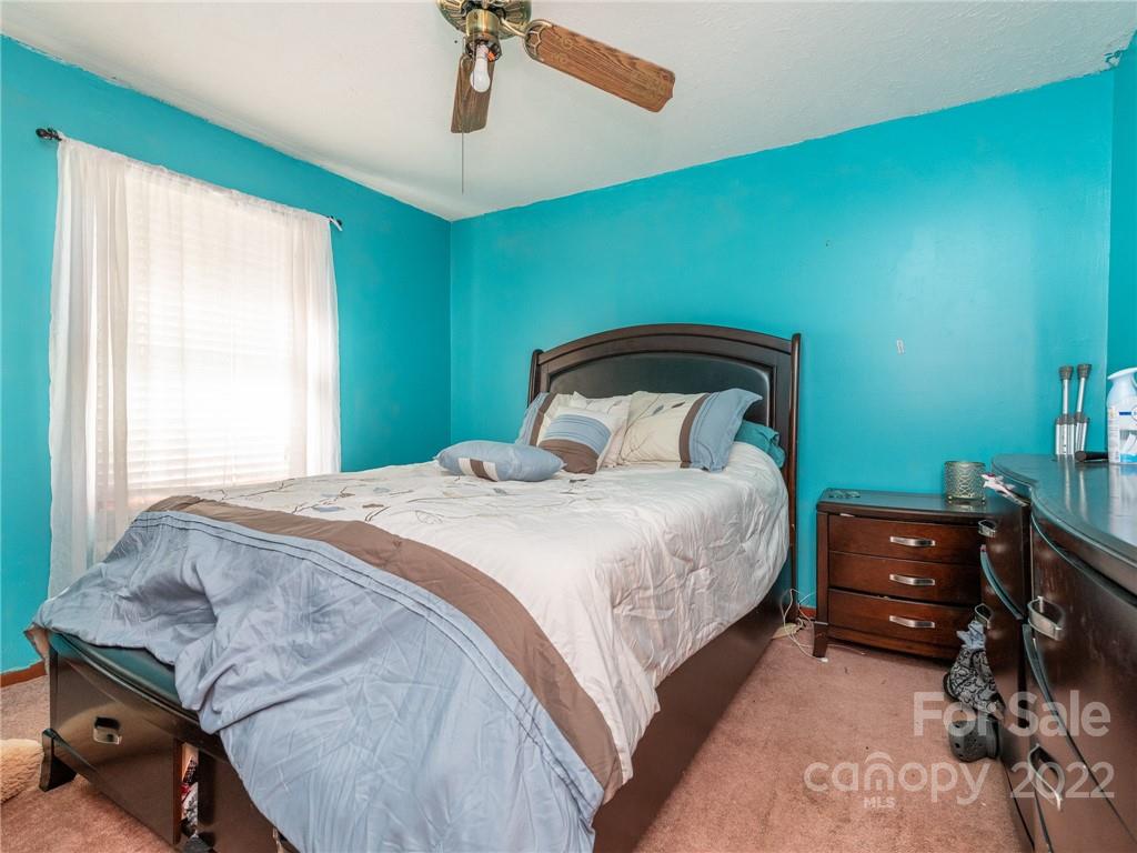 162 Alex Road Cleveland, NC 27013 - Photo 18 of 30 a bedroom with a bed and a chandelier