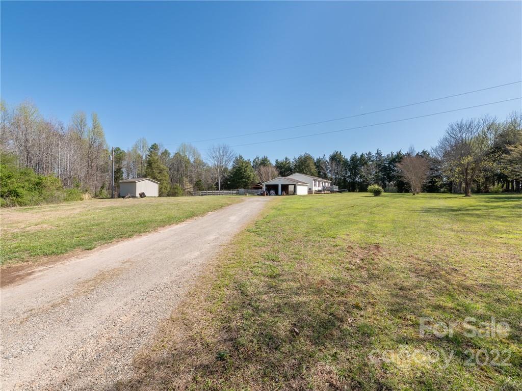 162 Alex Road Cleveland, NC 27013 - Photo 25 of 30 a view of a field with trees in the background