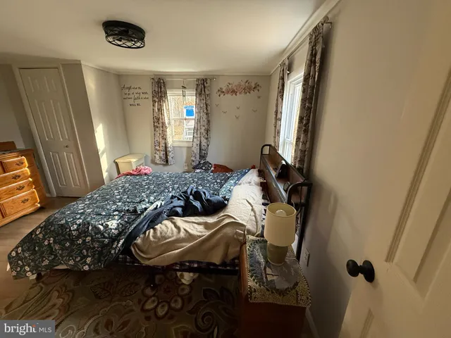 a bedroom with a bed and a mirror