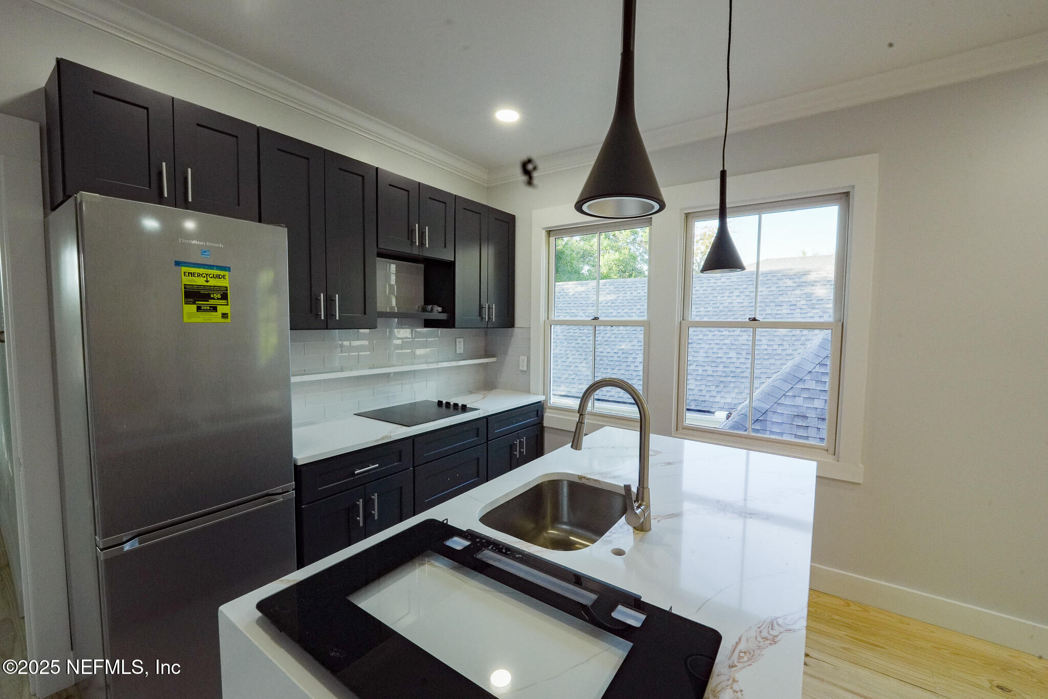 1932 Hubbard Street, Unit 1 Jacksonville, FL 32206 - Photo 3 of 5 a kitchen with a refrigerator a sink and wooden floor