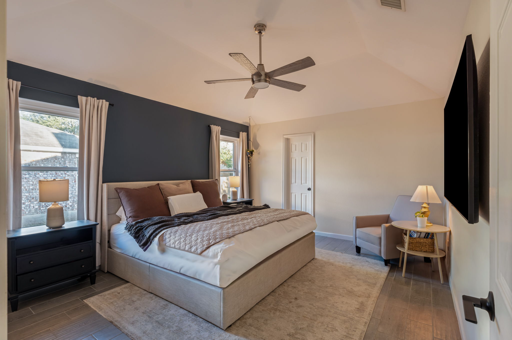 164 Johnnys Way Kyle, TX 78640 - Photo 12 of 24 a bedroom with a bed wooden floor and window