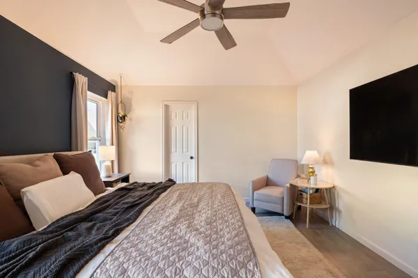 a bedroom with a bed and a flat screen tv