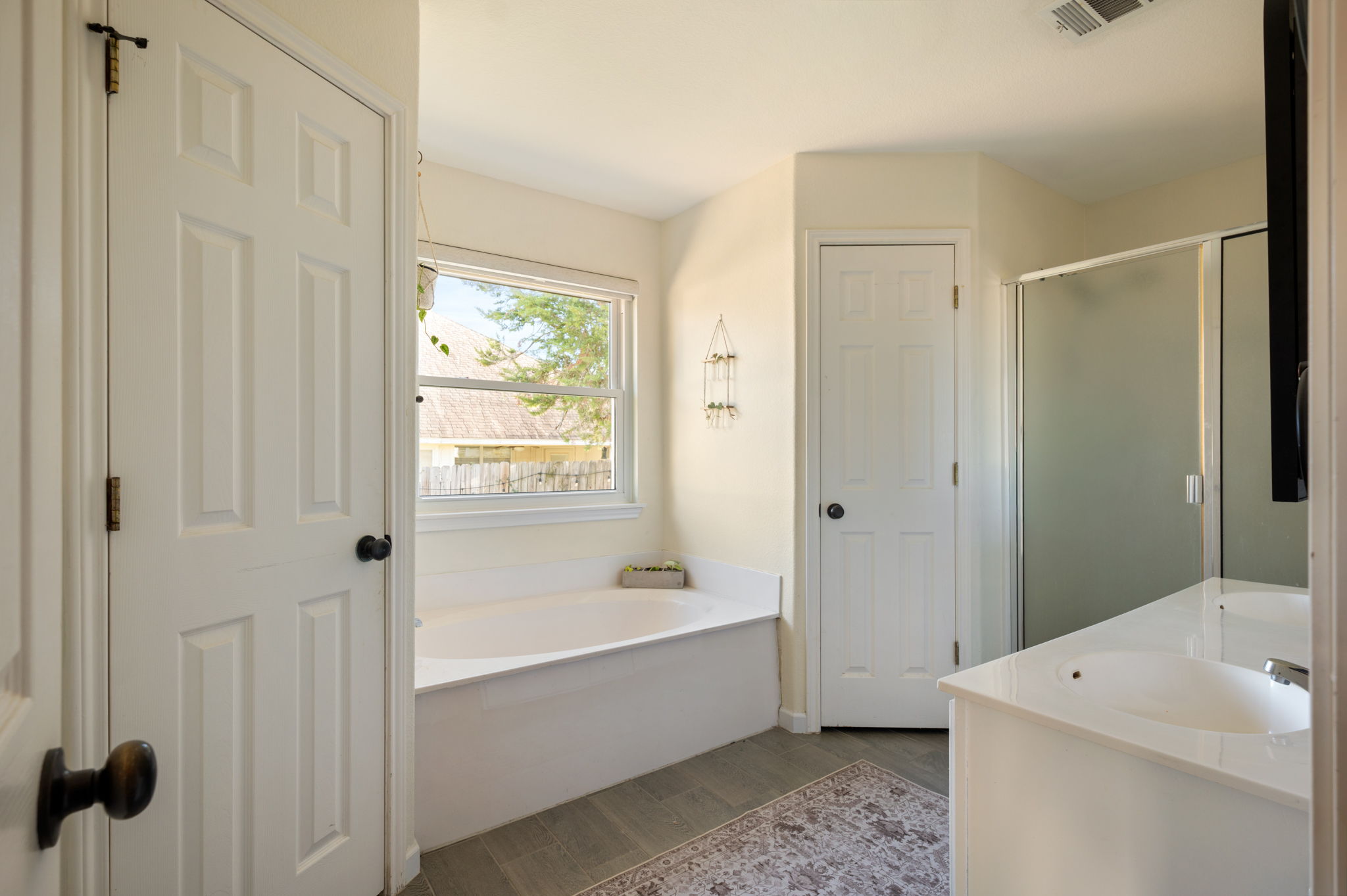 164 Johnnys Way Kyle, TX 78640 - Photo 14 of 24 a bathroom with a tub a sink and a window
