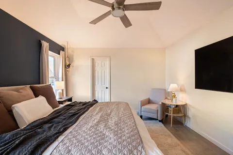 a bedroom with a bed and a flat screen tv