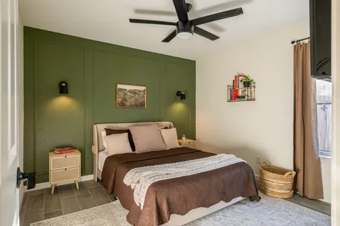 a bedroom with a bed and a chandelier