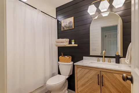 a bathroom with a sink a toilet and a mirror