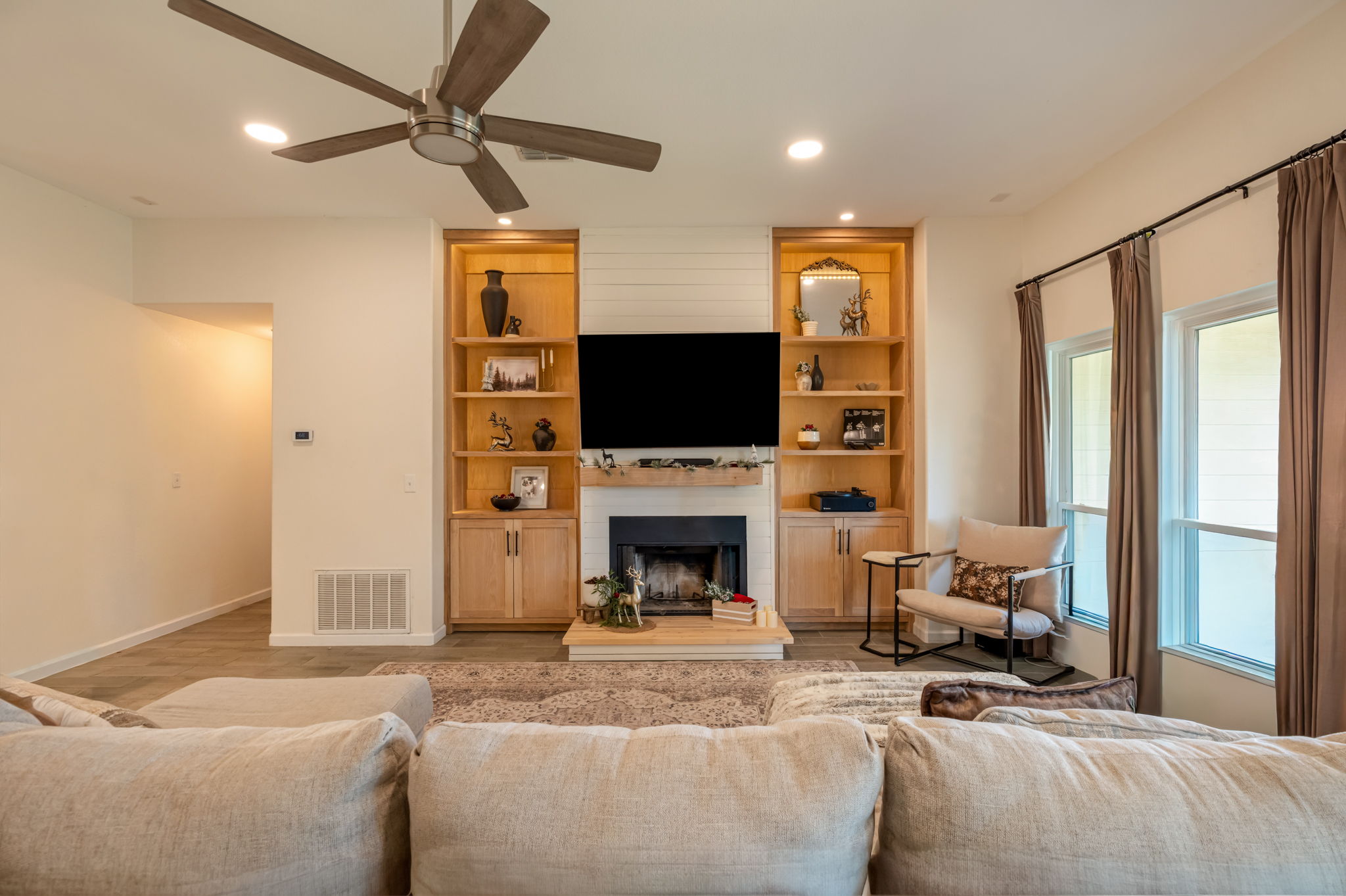 164 Johnnys Way Kyle, TX 78640 - Photo 4 of 24 a living room with furniture a fireplace and a flat screen tv