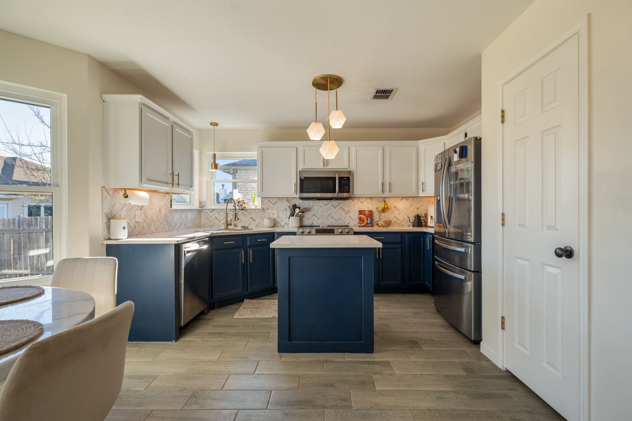 164 Johnnys Way Kyle, TX 78640 - Photo 8 of 24 a kitchen with a refrigerator and a stove