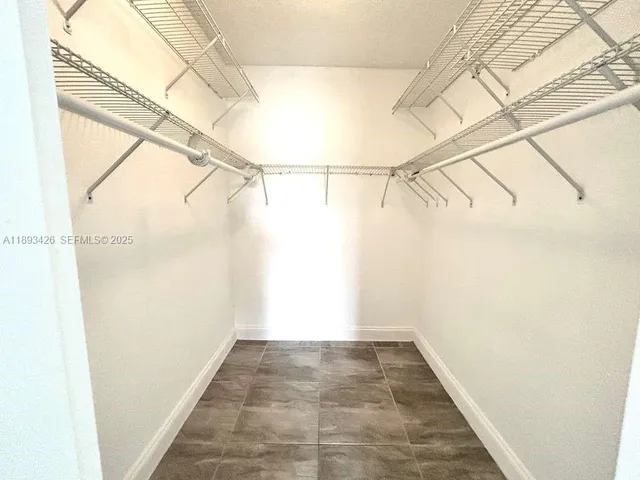 a bathroom with a sink a toilet a mirror and shower