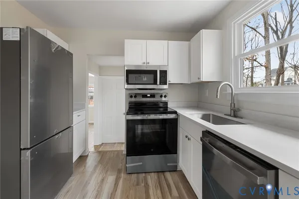 a kitchen with a sink stove and refrigerator