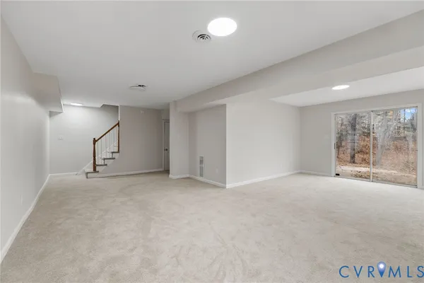 an empty room with windows and natural light