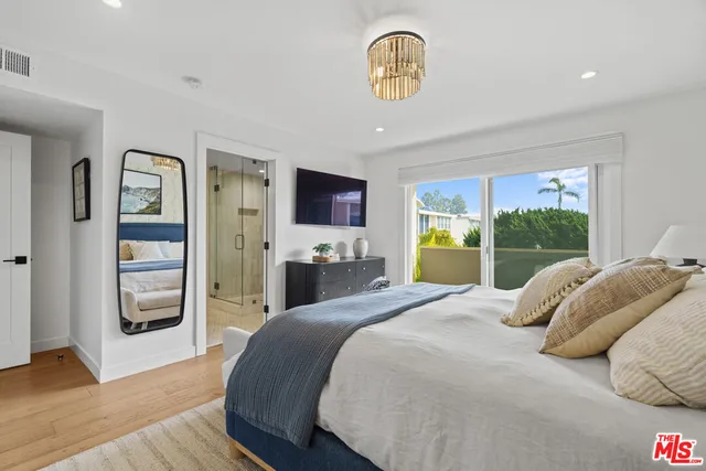 a bedroom with a bed and a large window