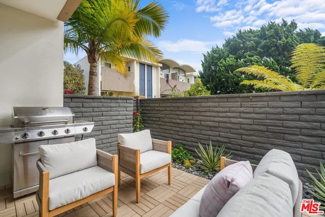 a view of a patio with couches chairs and a fire pit
