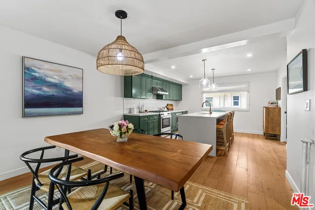 a view of a dining room with furniture wooden floor and chandelier