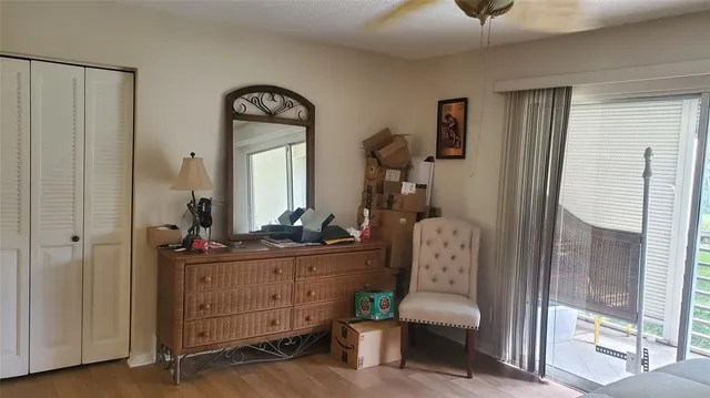 a view of a hallway with windows and livingroom view
