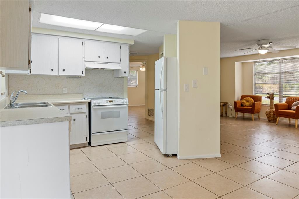 340 Periwinkle Road Venice, FL 34293 - Photo 13 of 36 a kitchen with a stove a sink and a refrigerator