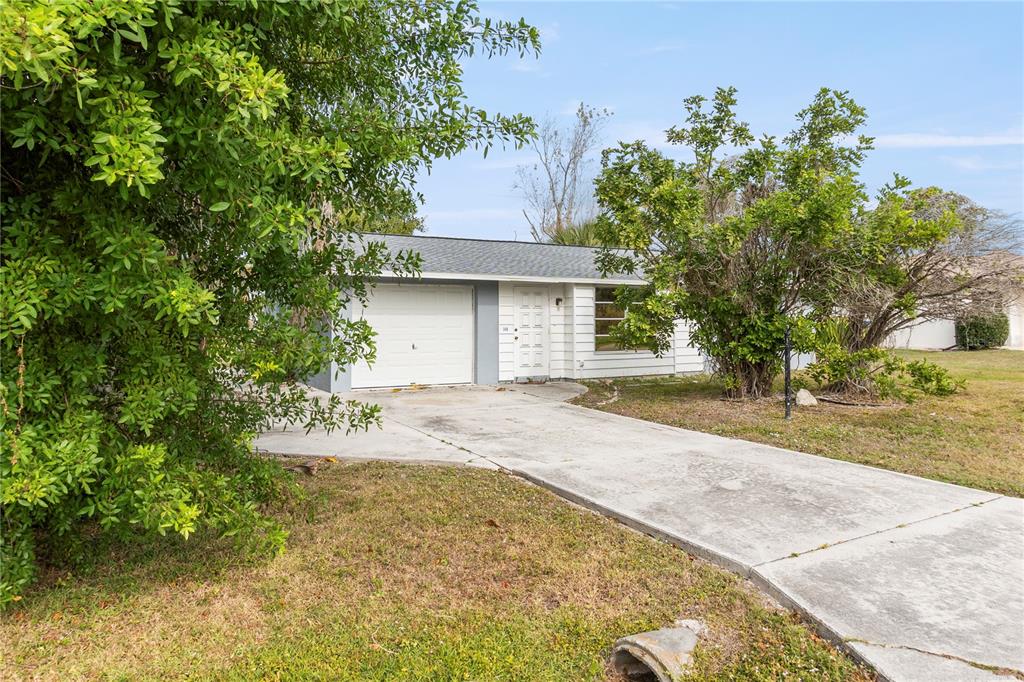 340 Periwinkle Road Venice, FL 34293 - Photo 5 of 36 a view of a house with a yard and garage