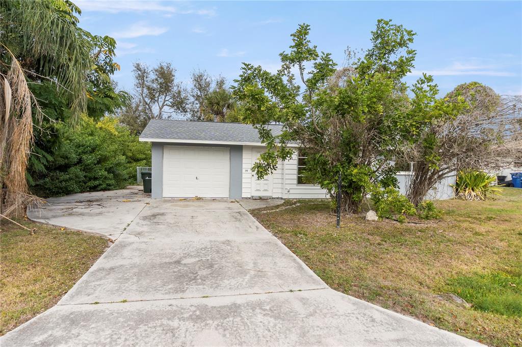 340 Periwinkle Road Venice, FL 34293 - Photo 7 of 36 a front view of a house with a yard and trees
