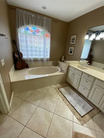 a bathroom with a sink a vanity and bathtub