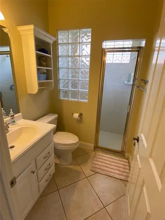a bathroom with a sink a toilet a mirror and shower