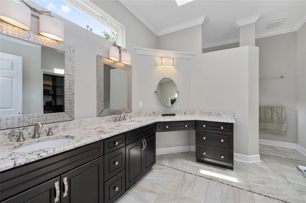 8942 Southwest 25 Road Gainesville, FL 32608 - Photo 10 of 22 a bathroom with a granite countertop double vanity sink and mirror