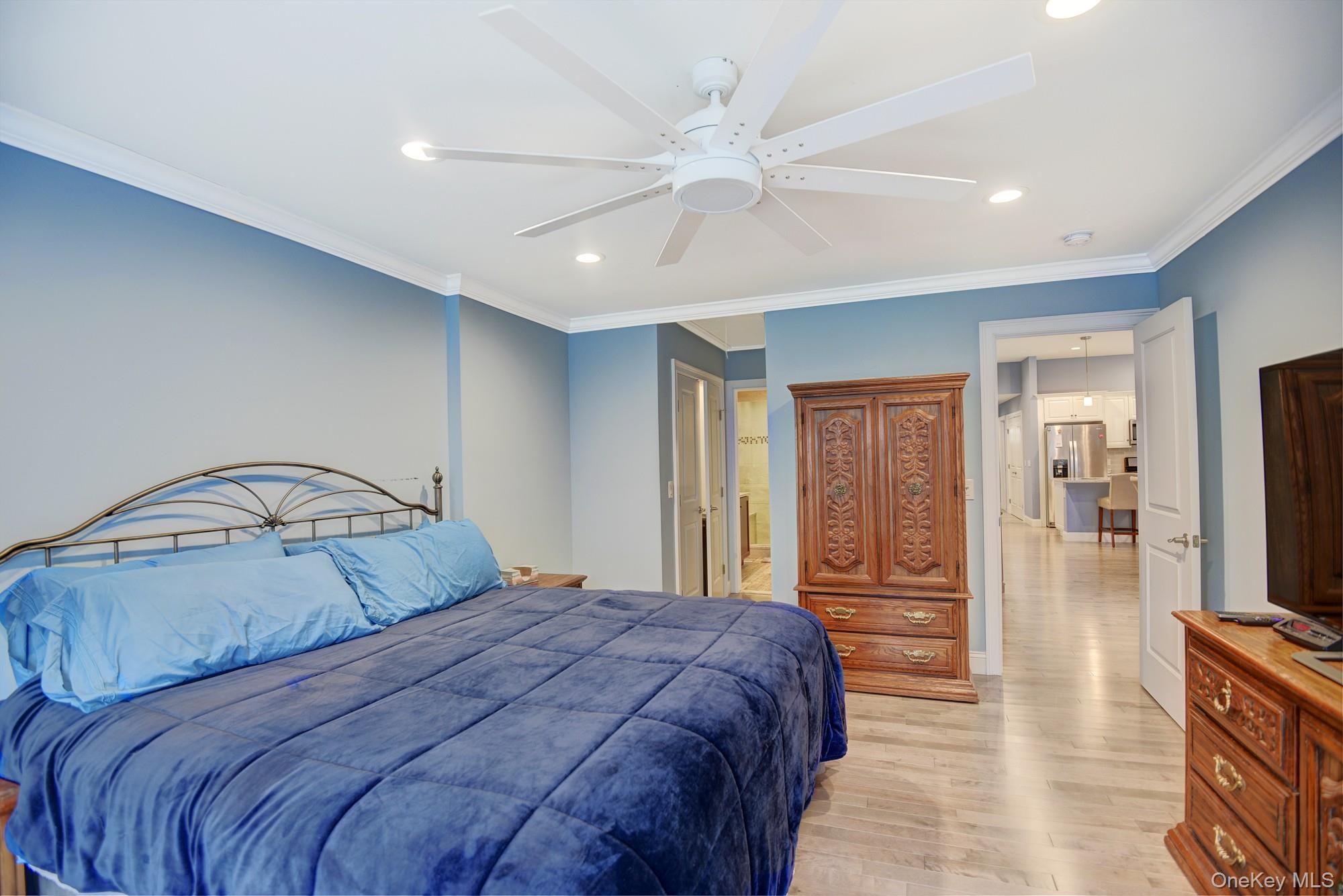 2 Spruce Place Bohemia, NY 11716 - Photo 13 of 34 a bedroom with a large bed and a chandelier