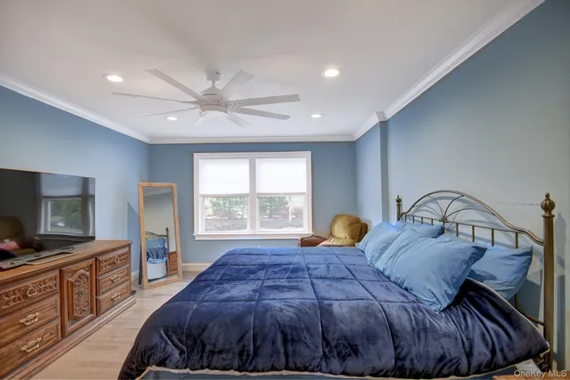 a bedroom with a large bed and a window