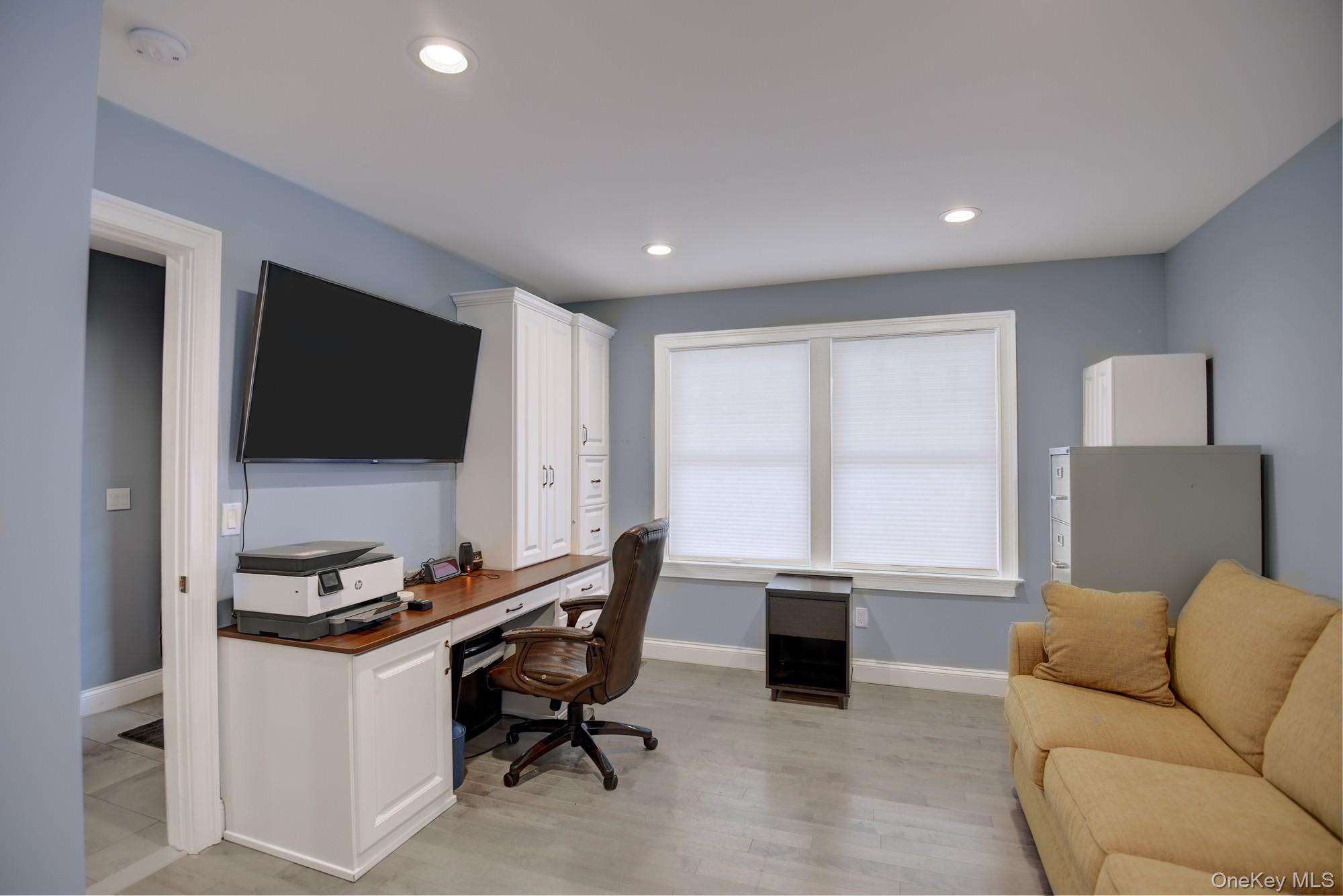2 Spruce Place Bohemia, NY 11716 - Photo 18 of 34 a living room with furniture and a flat screen tv