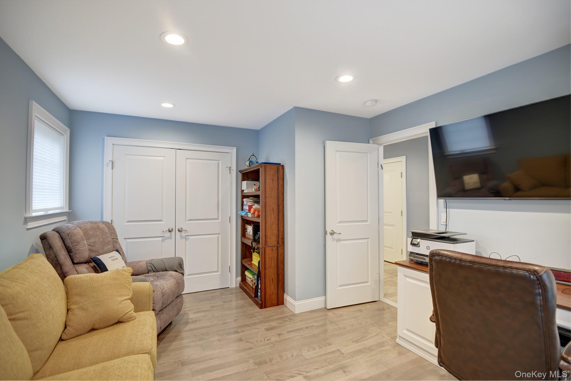 2 Spruce Place Bohemia, NY 11716 - Photo 19 of 34 a living room with furniture and a flat screen tv