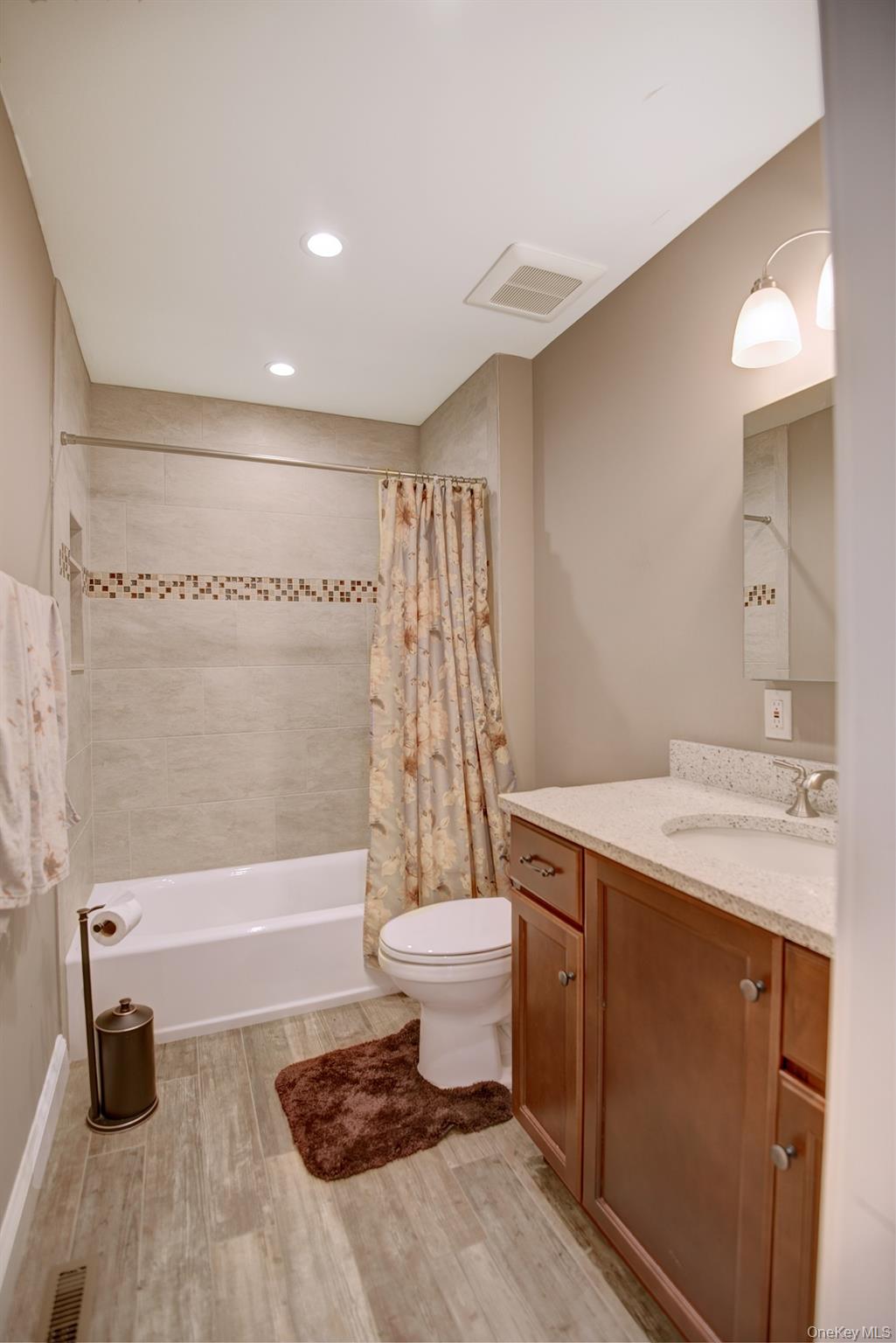 2 Spruce Place Bohemia, NY 11716 - Photo 20 of 34 a bathroom with a sink toilet and shower