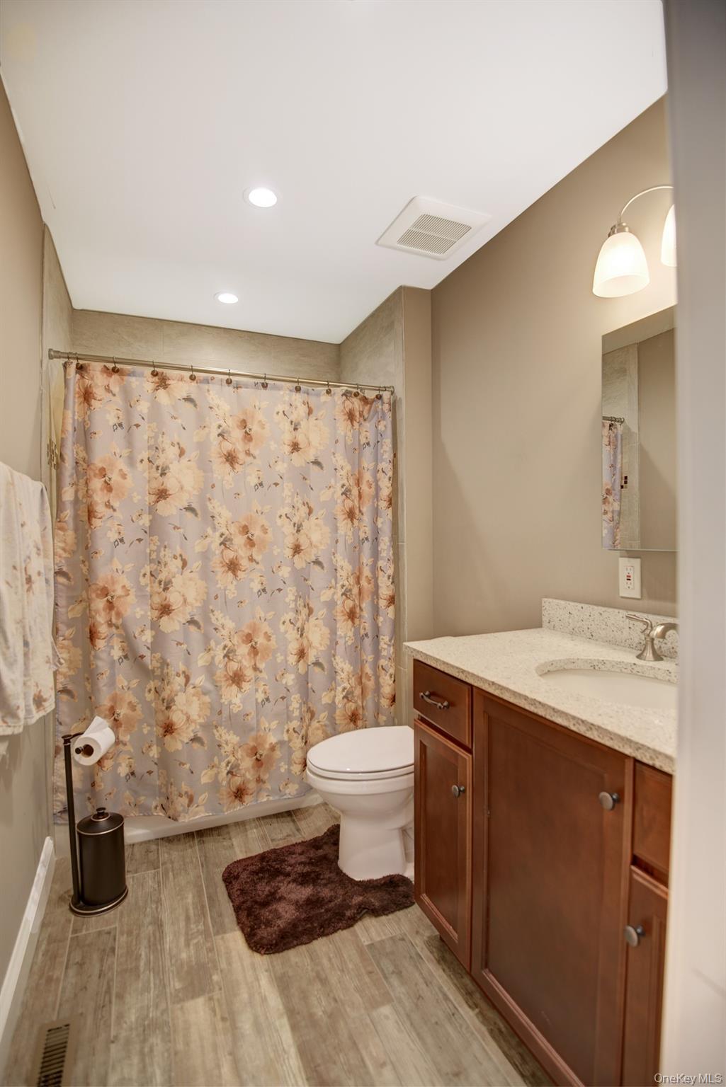 2 Spruce Place Bohemia, NY 11716 - Photo 21 of 34 a bathroom with a sink toilet and shower