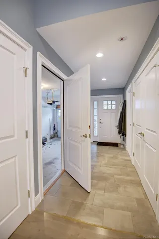 a view of a hallway with closet and bathroom