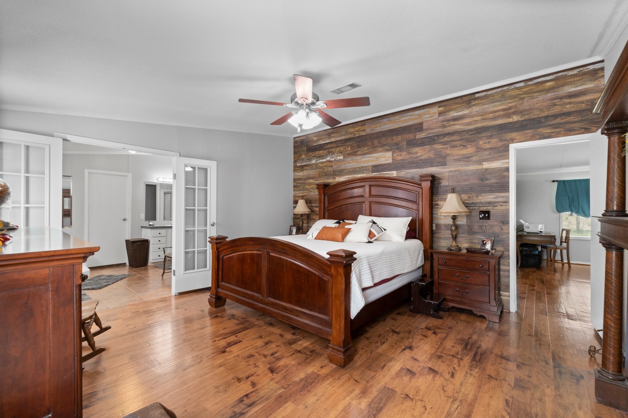 7105 Mt Zion Road New Waverly, TX 77358 - Photo 26 of 42 The tasteful feature wall adds a rustic feel to the primary bedroom.