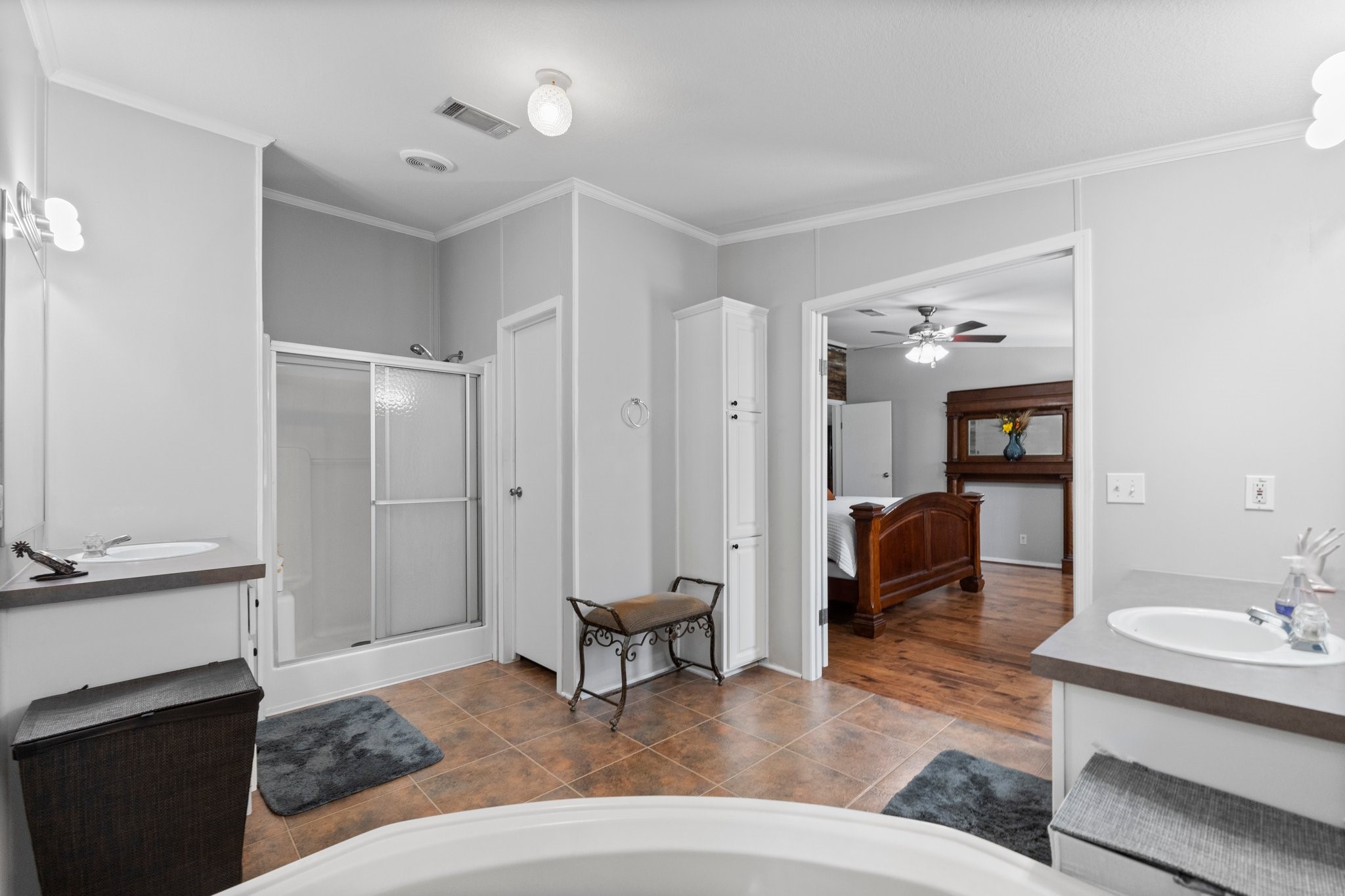 7105 Mt Zion Road New Waverly, TX 77358 - Photo 28 of 42 The primary bath features two vanities, each with a sink and a separate oversized soaking tub and shower.