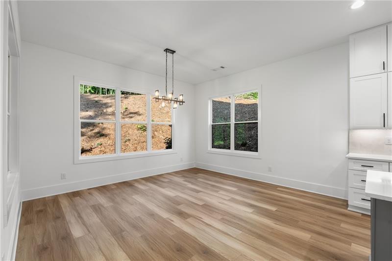 7252 Creekside Way Jefferson, GA 30549 - Photo 17 of 52 a view of an empty room with window wooden floor and a window