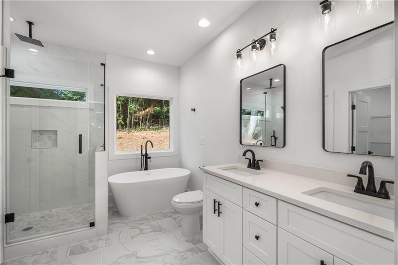 7252 Creekside Way Jefferson, GA 30549 - Photo 29 of 52 a bathroom with a double vanity sink mirror and shower