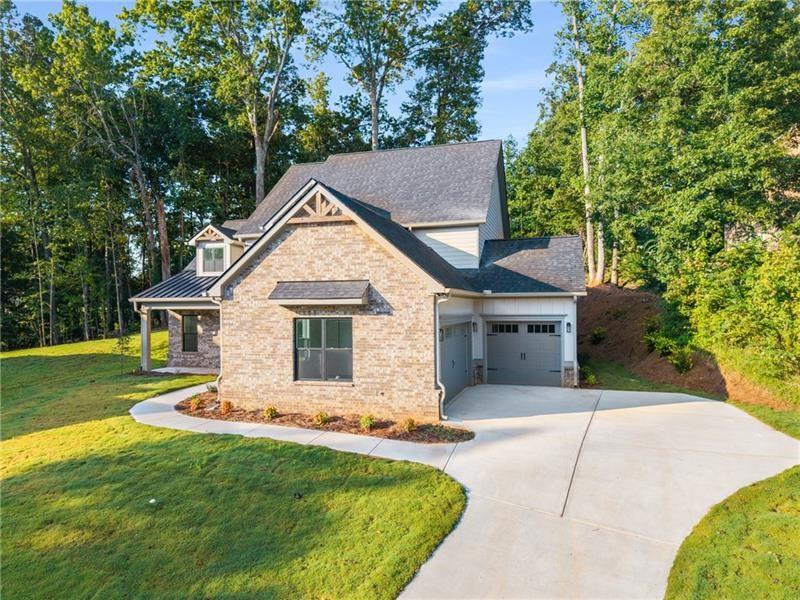 7252 Creekside Way Jefferson, GA 30549 - Photo 3 of 52 a front view of a house with a garden and yard